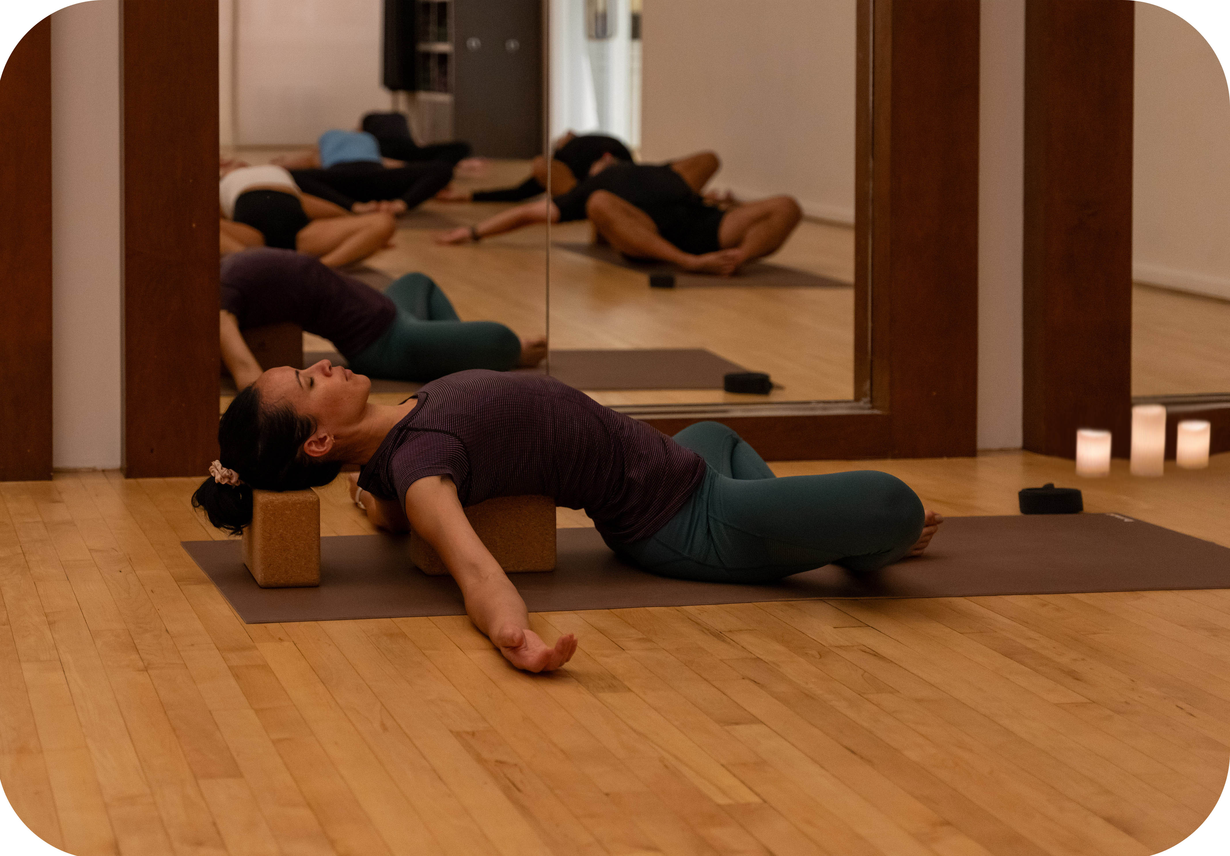 Young woman meditating in a Candlelight Yoga & Meditation class at the Adelaide Club