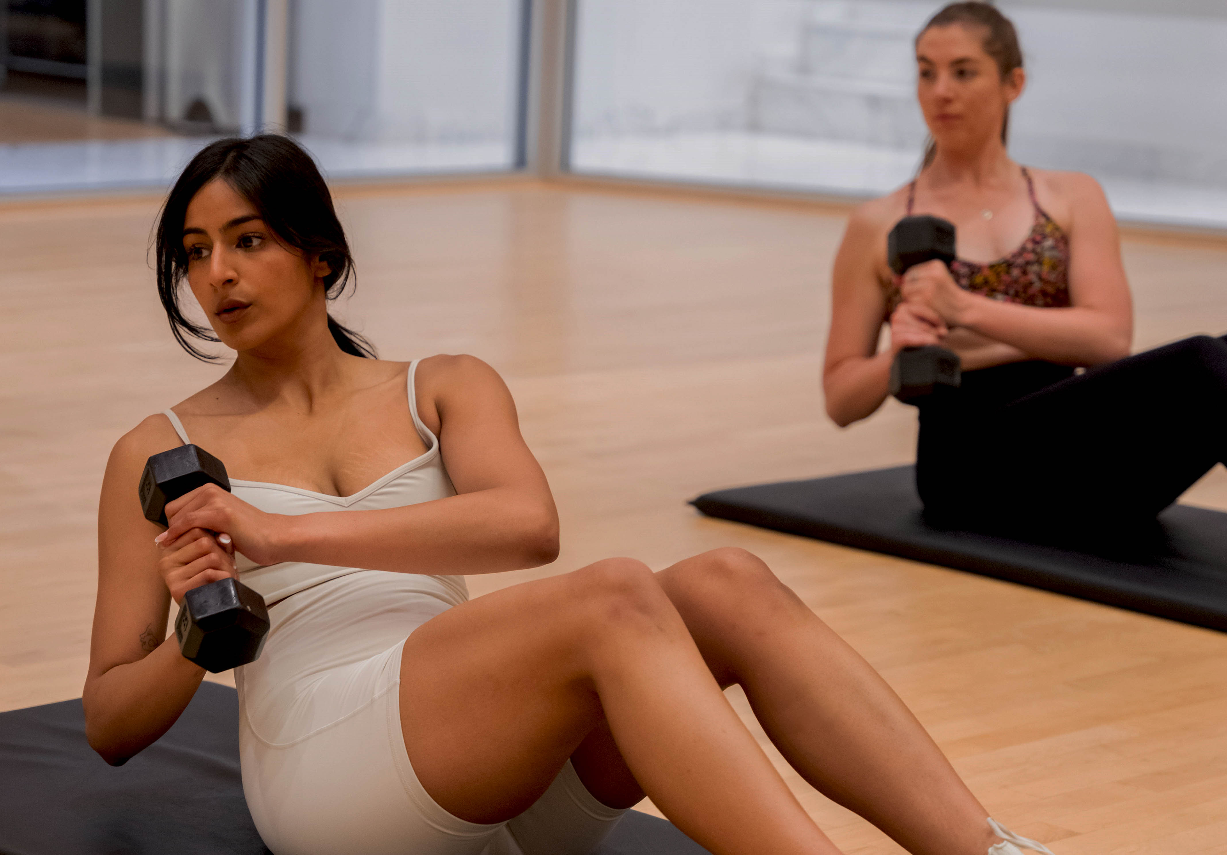 Group of young men and women lifting weights in a Power Intervals group fitness class in the Adelaide Club's Fusion Studio