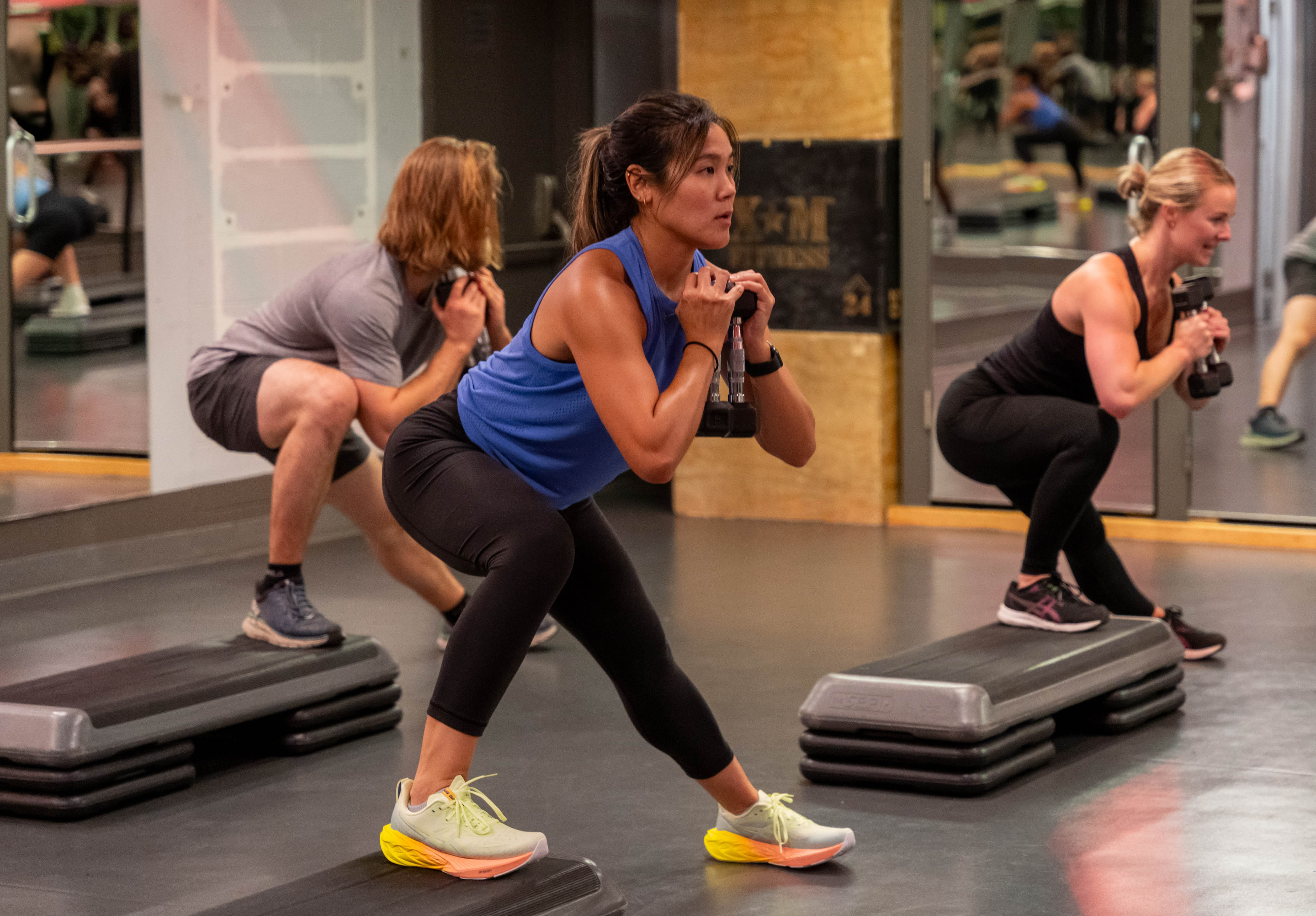Step group fitness class using weight training at the Adelaide Club featuring young men and women